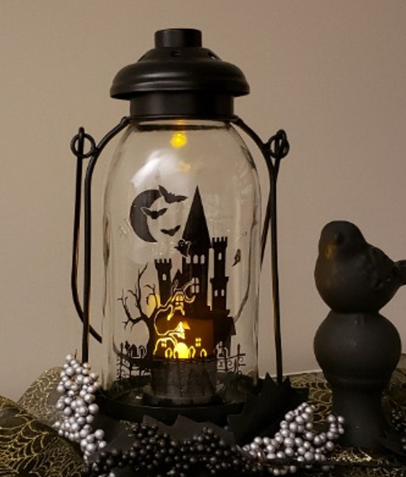 Lantern with haunted house decal